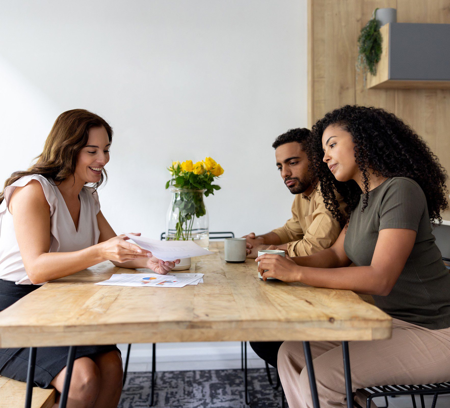 Couple discussing paperwork with agent